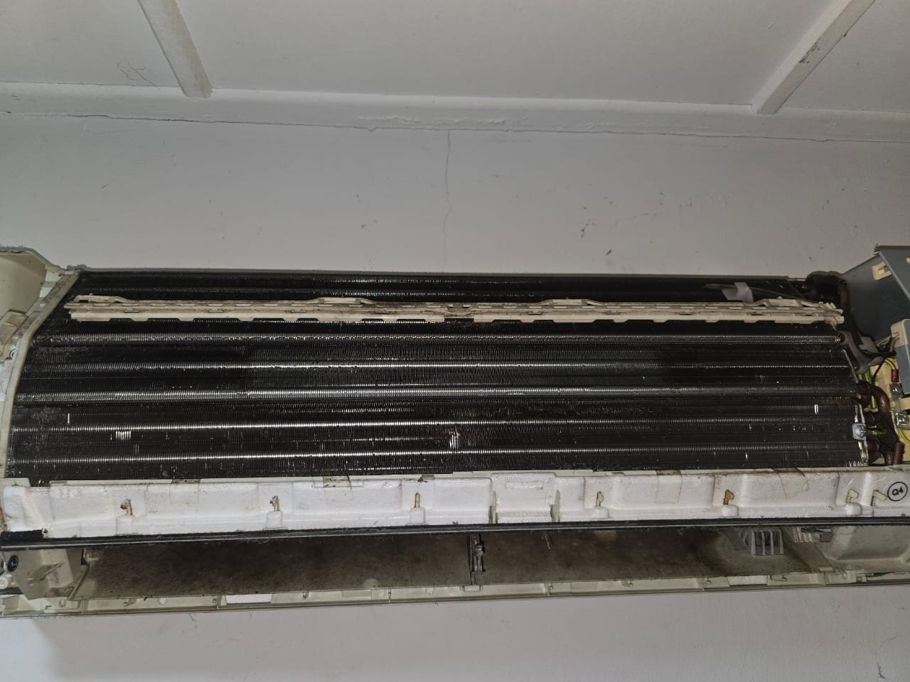 Split aircond service in progress on a wall unit in Bukit Indah, Johor Bahru