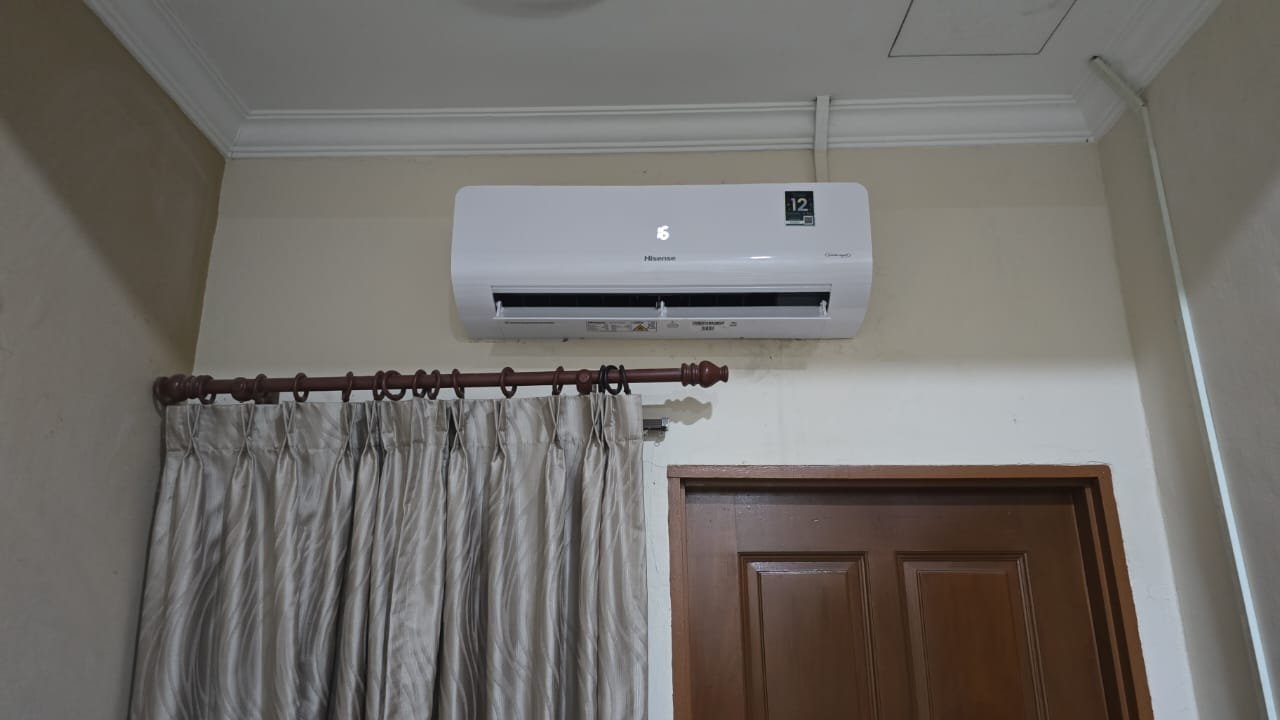 Outdoor split aircond condenser installed by RumahPro on Malaysian home exterior