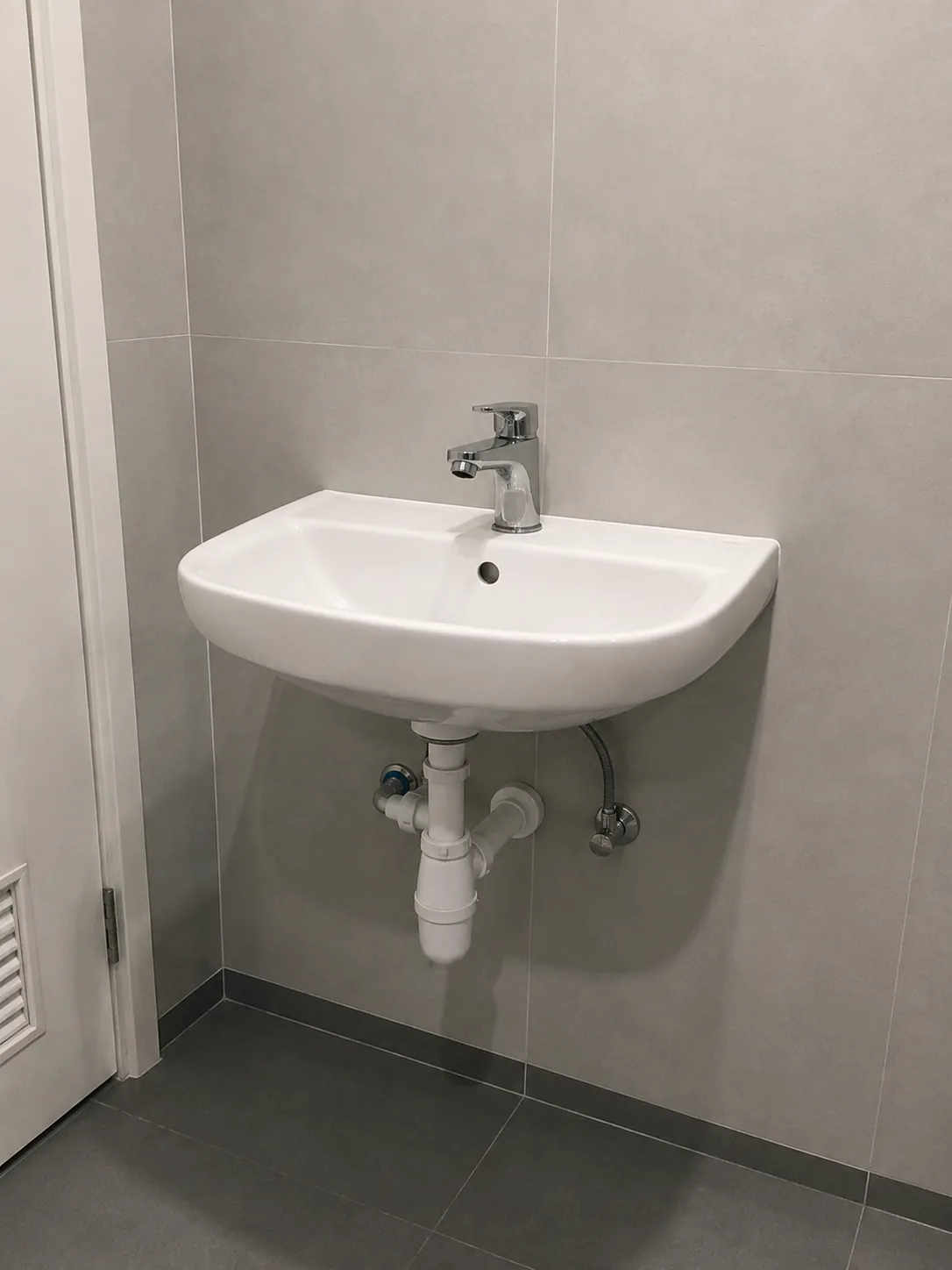 Washroom washbasin installation with drainage connection by RumahPro Malaysia